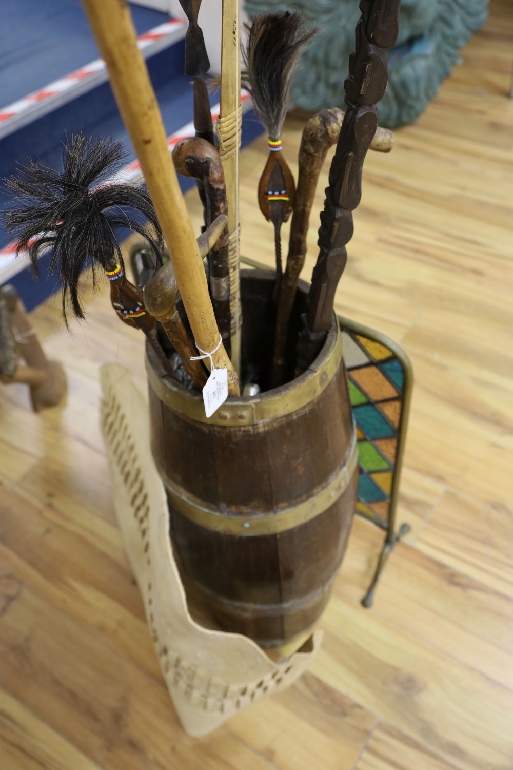 A brass bound coopered oak stickstand, assorted sticks a firescreen etc